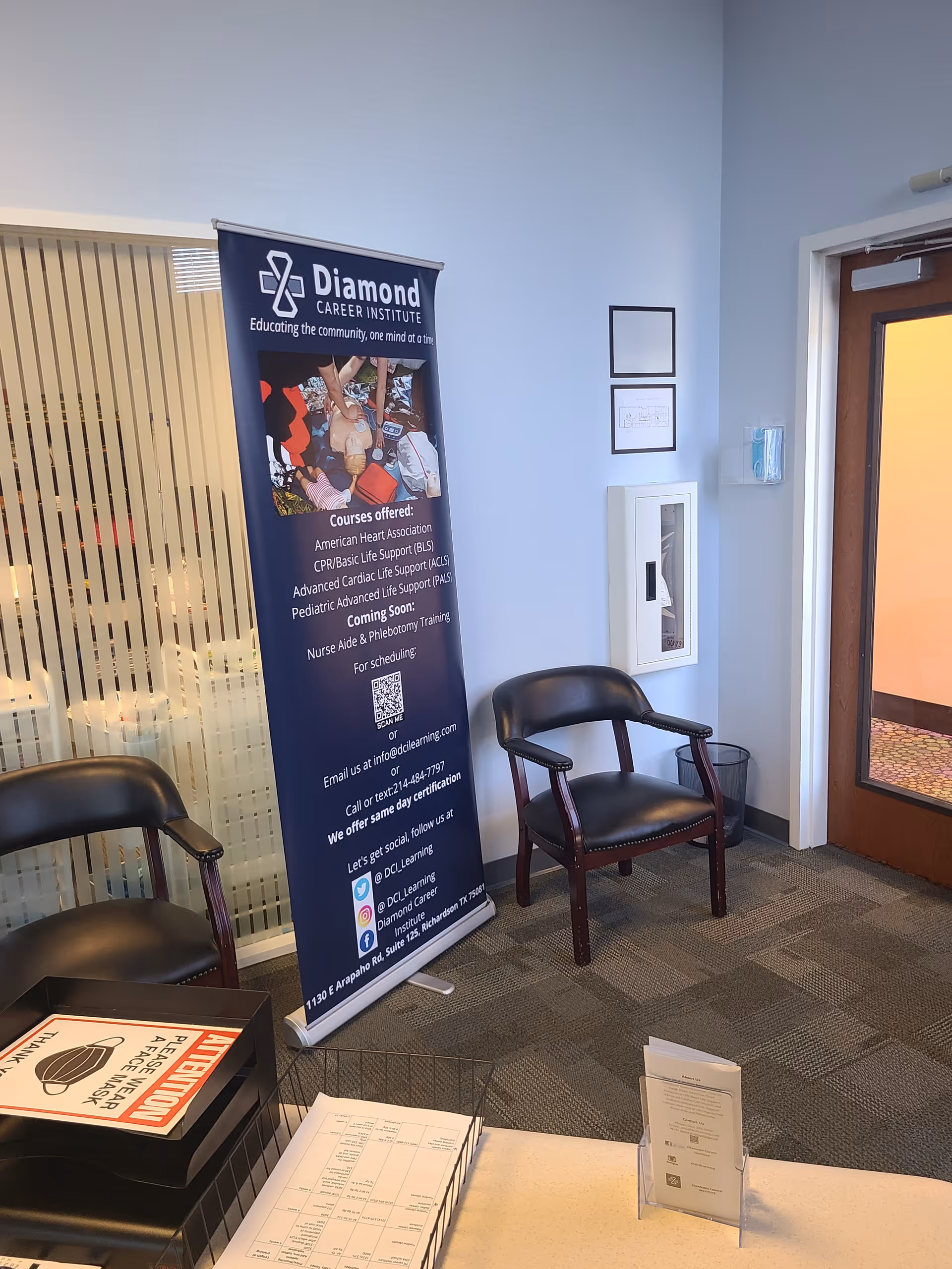 Lobby area with Diamond Career Institute banner, two chairs, a doorway, and a reception desk.