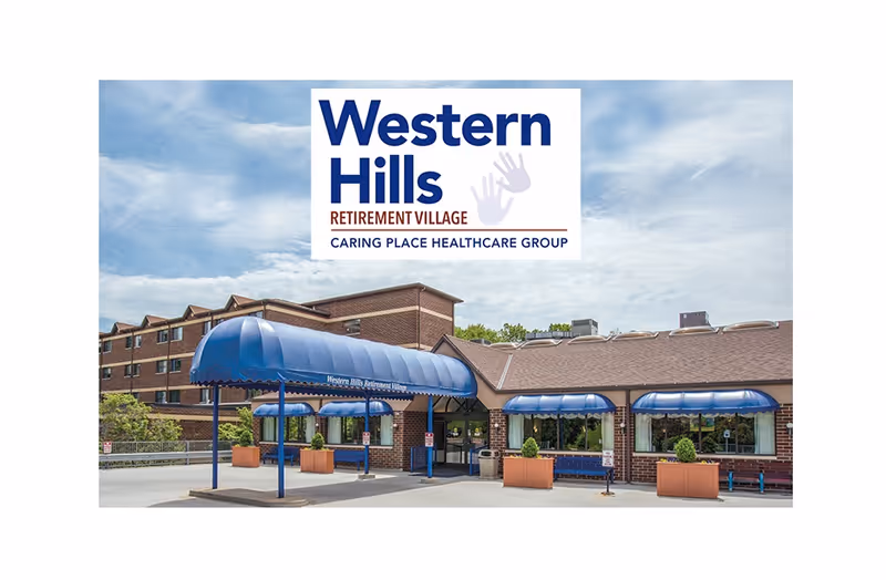 Front exterior of Western Hills Retirement Village with blue canopies and signage overhead.