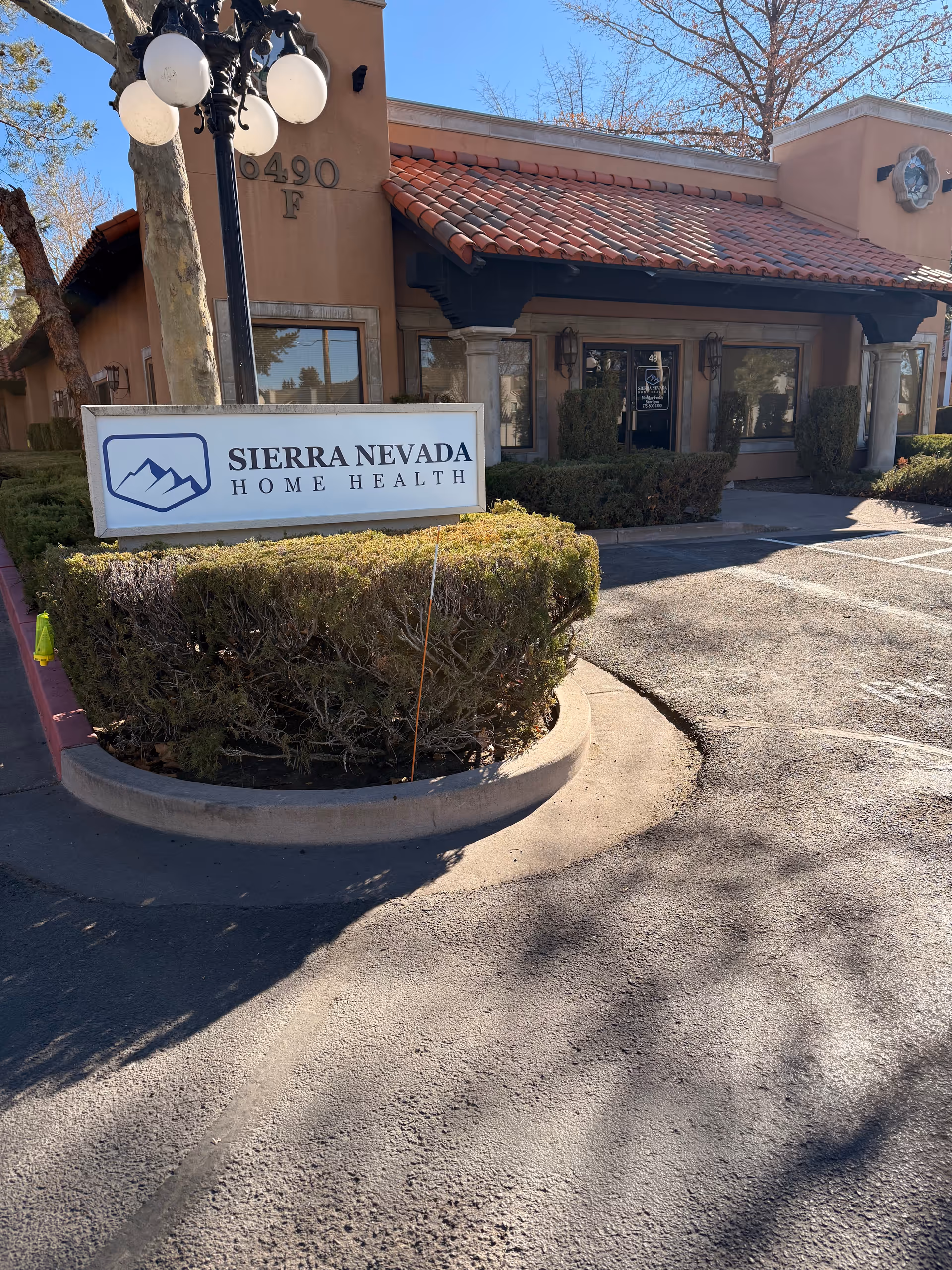 Exterior view of Sierra Nevada Home Health building with sign and entrance.