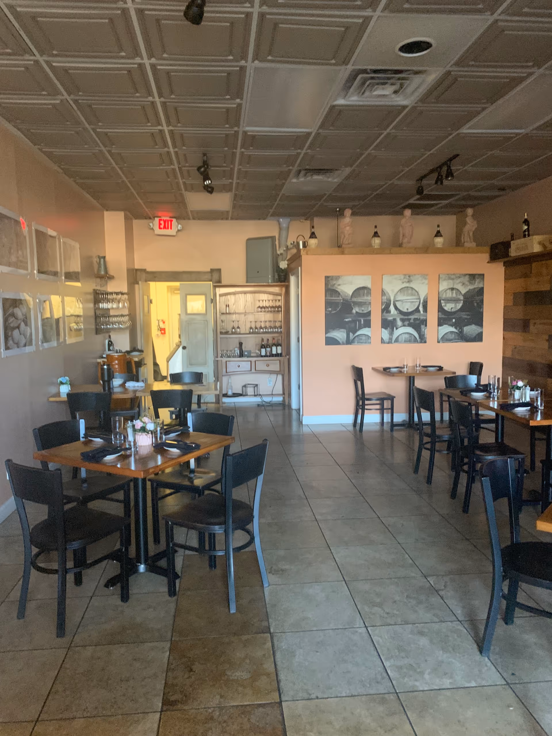 Casual dining room with multiple tables, chairs, and a bar area in a senior care facility.