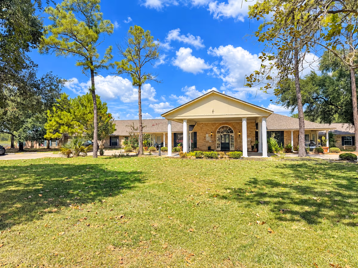 Front view of Columbus Oaks Healthcare Community entrance with lawn and trees.