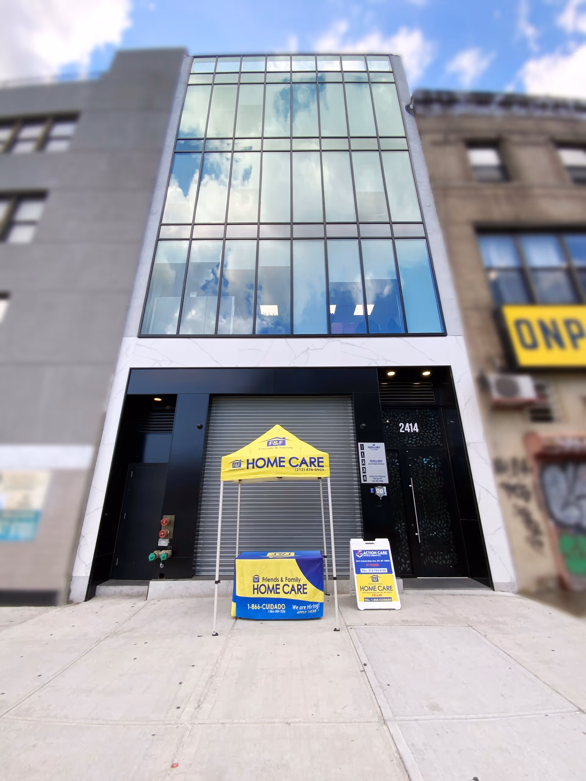Tall glass-front building with a HOME CARE tent sign and a sidewalk.