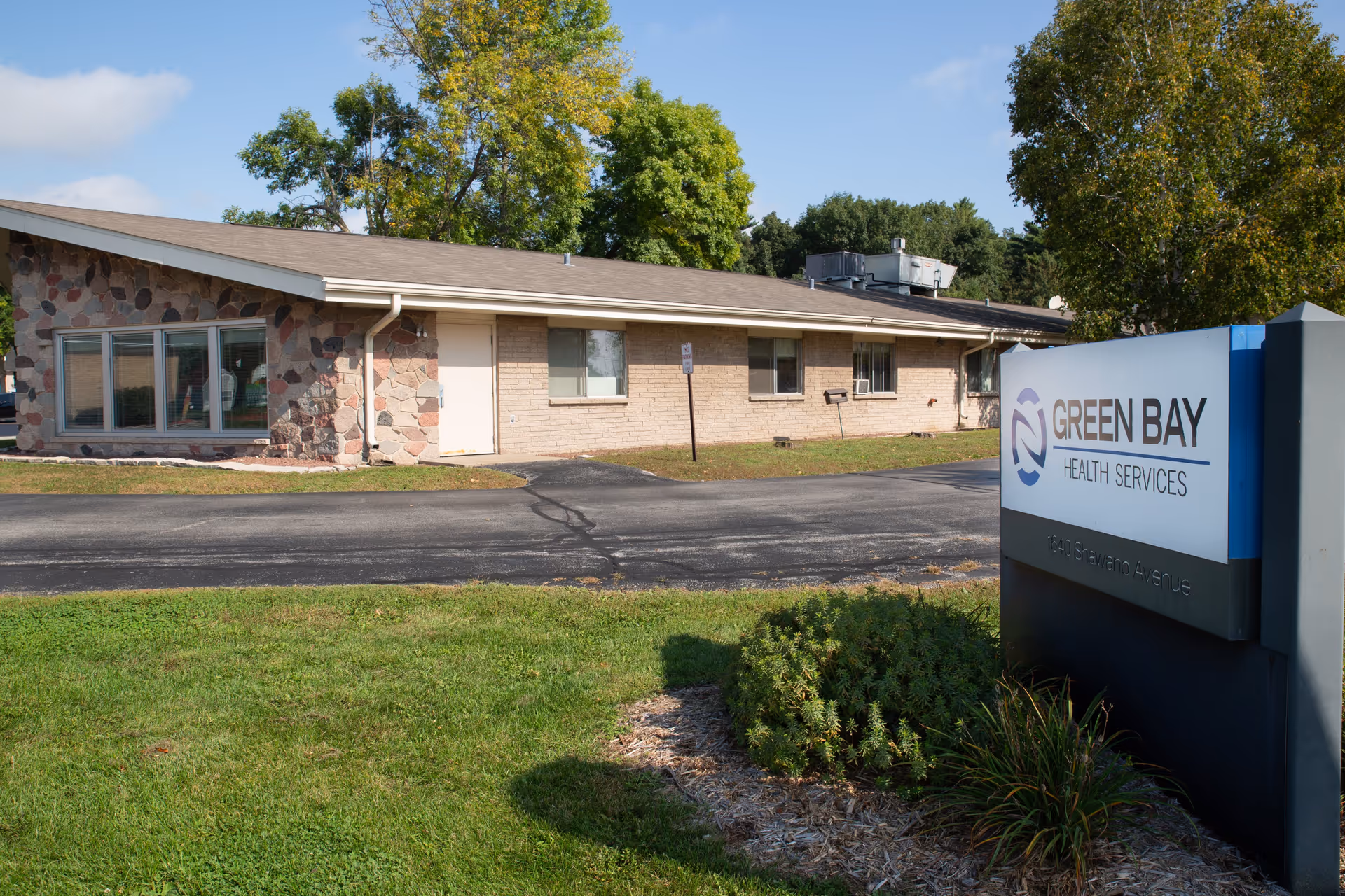 Single-story brick building with a Green Bay Health Services sign on the right.