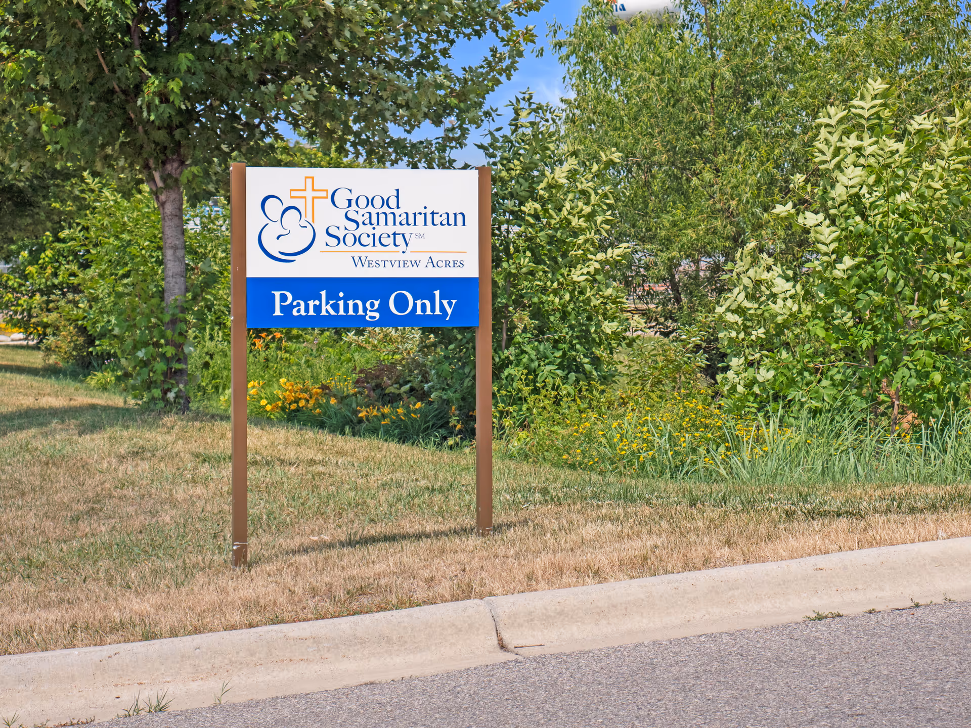 Exterior view of a Good Samaritan Society sign with 'Parking Only' near landscaping