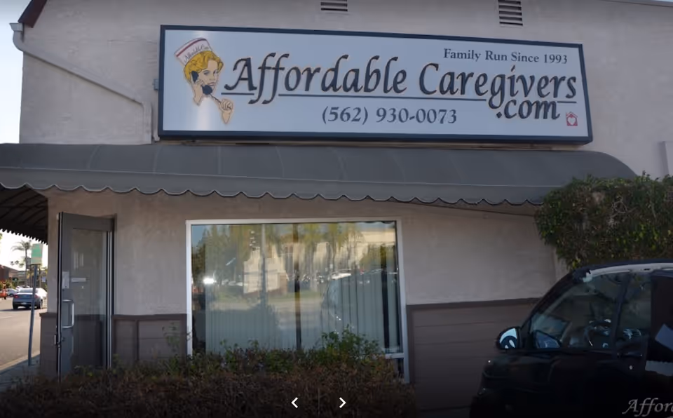 Exterior view of Affordable Caregivers storefront with sign, awning, and a parked car.