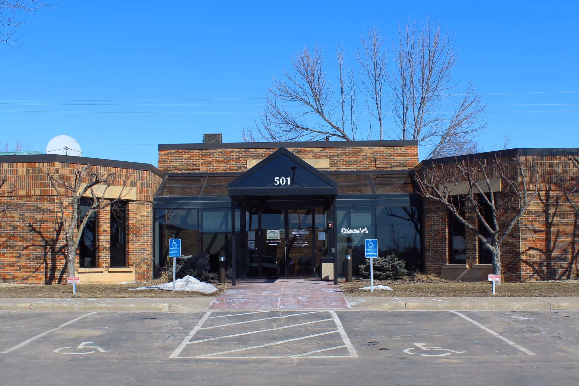 Ridgeview Hospice exterior front entrance with glass doors and parking