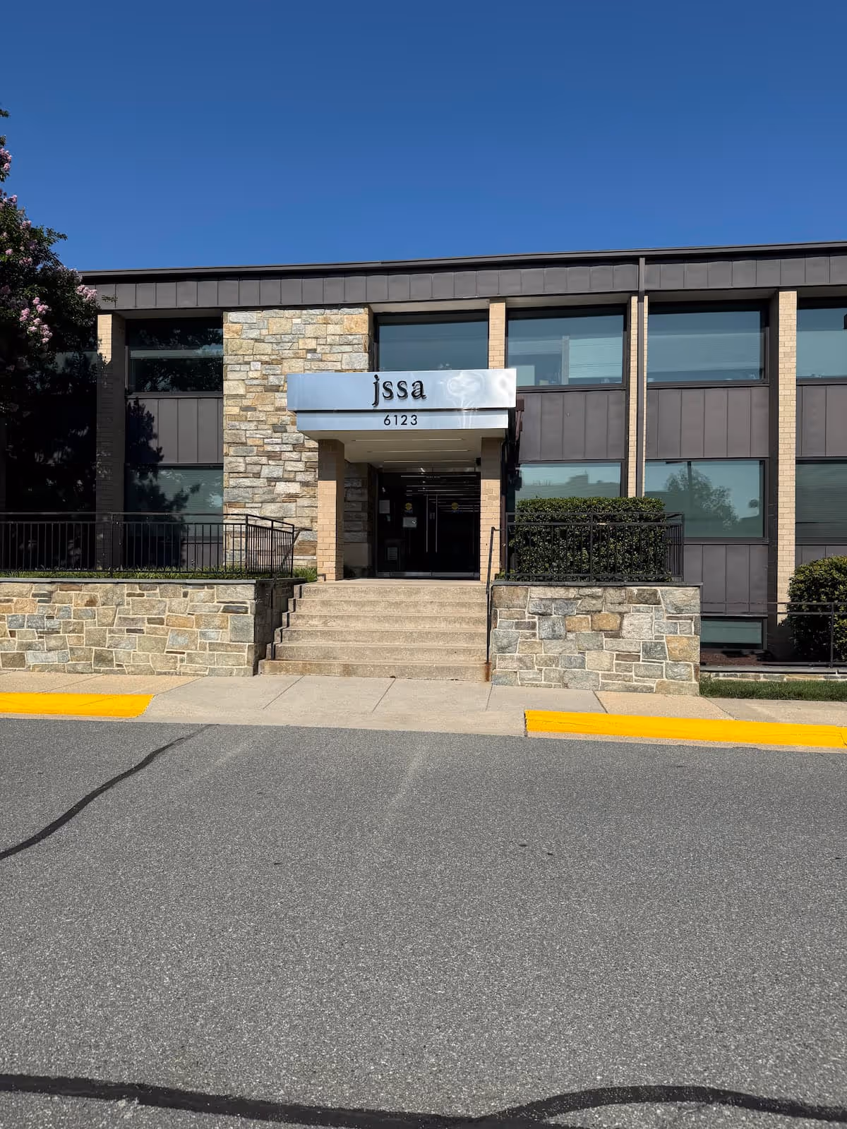 Facade of a senior living facility entrance with stone accents and JSSA signage.