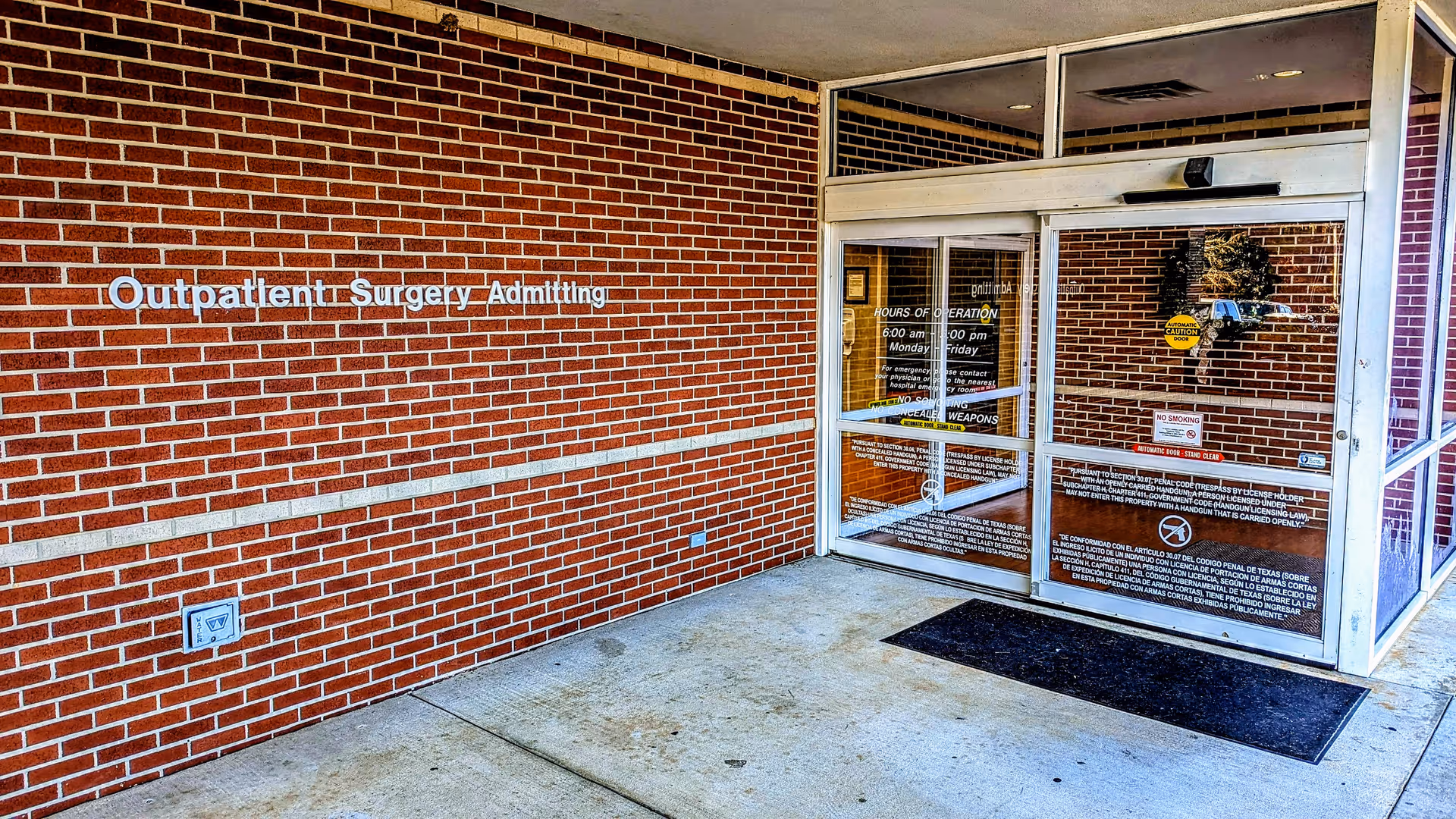Brick exterior with glass doors labeled Outpatients Surgery Admitting at Texarkana Surgery Center.