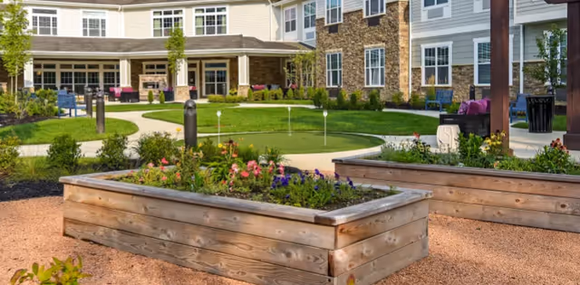 Exterior view of The Commons on Meridian courtyard with planters and green lawn.