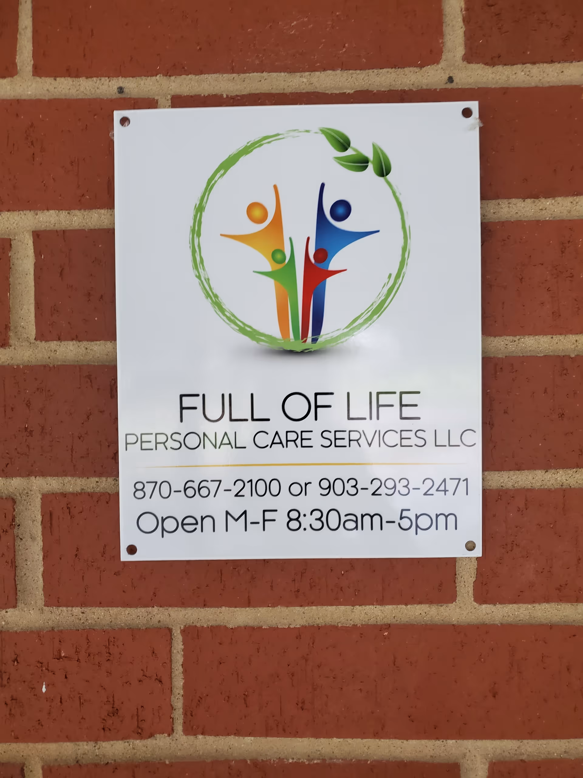 Exterior brick wall displays a sign for Full of Life Personal Care Services LLC.
