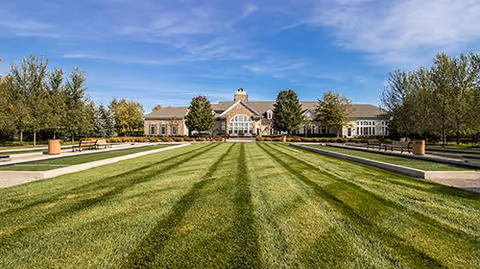 Wide exterior view of Bridgewater Brownstown campus with green lawn and trees