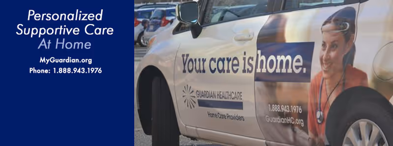 Branded Guardian Healthcare van beside a blue promotional banner reading 'Your care is home'.