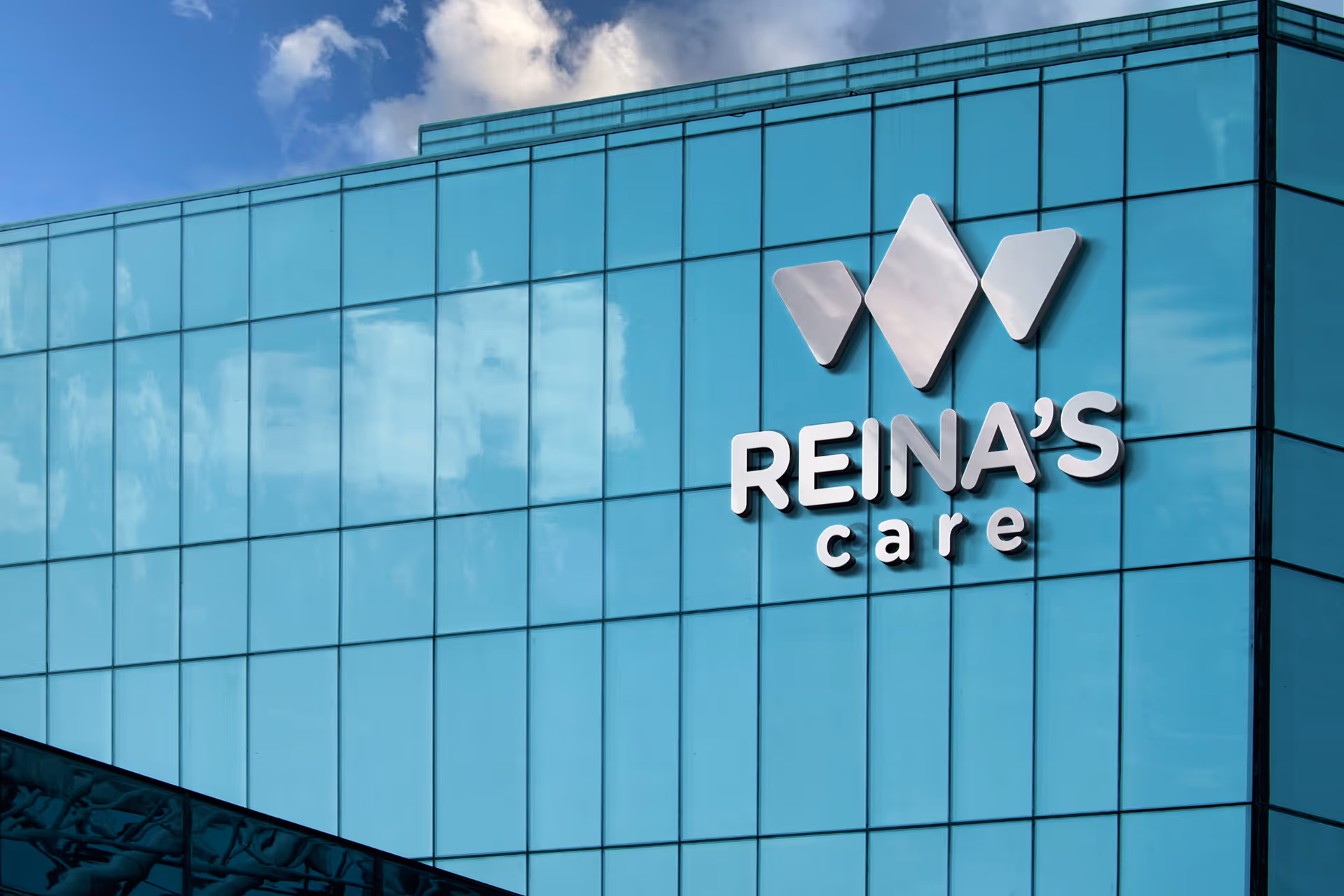 Blue glass building exterior with Reina's care sign.