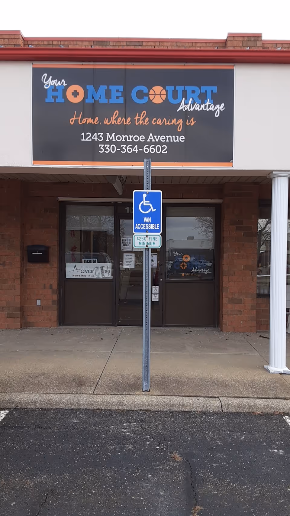 Exterior of Advantage Home Health Services building with large sign and double doors.