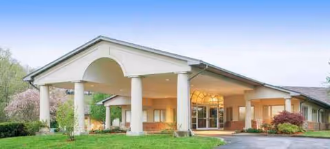 Edmonson Center exterior entrance featuring tall white columns and a covered portico over glass doors.