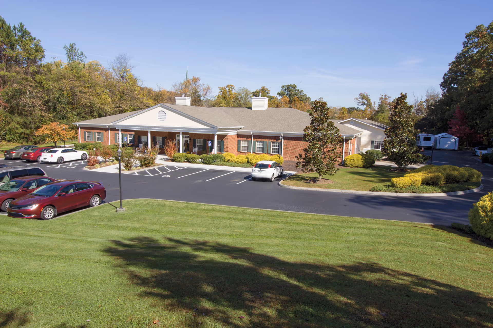 Exterior view of Brookdale Colonial Heights, brick senior living facility with parking and landscaping.