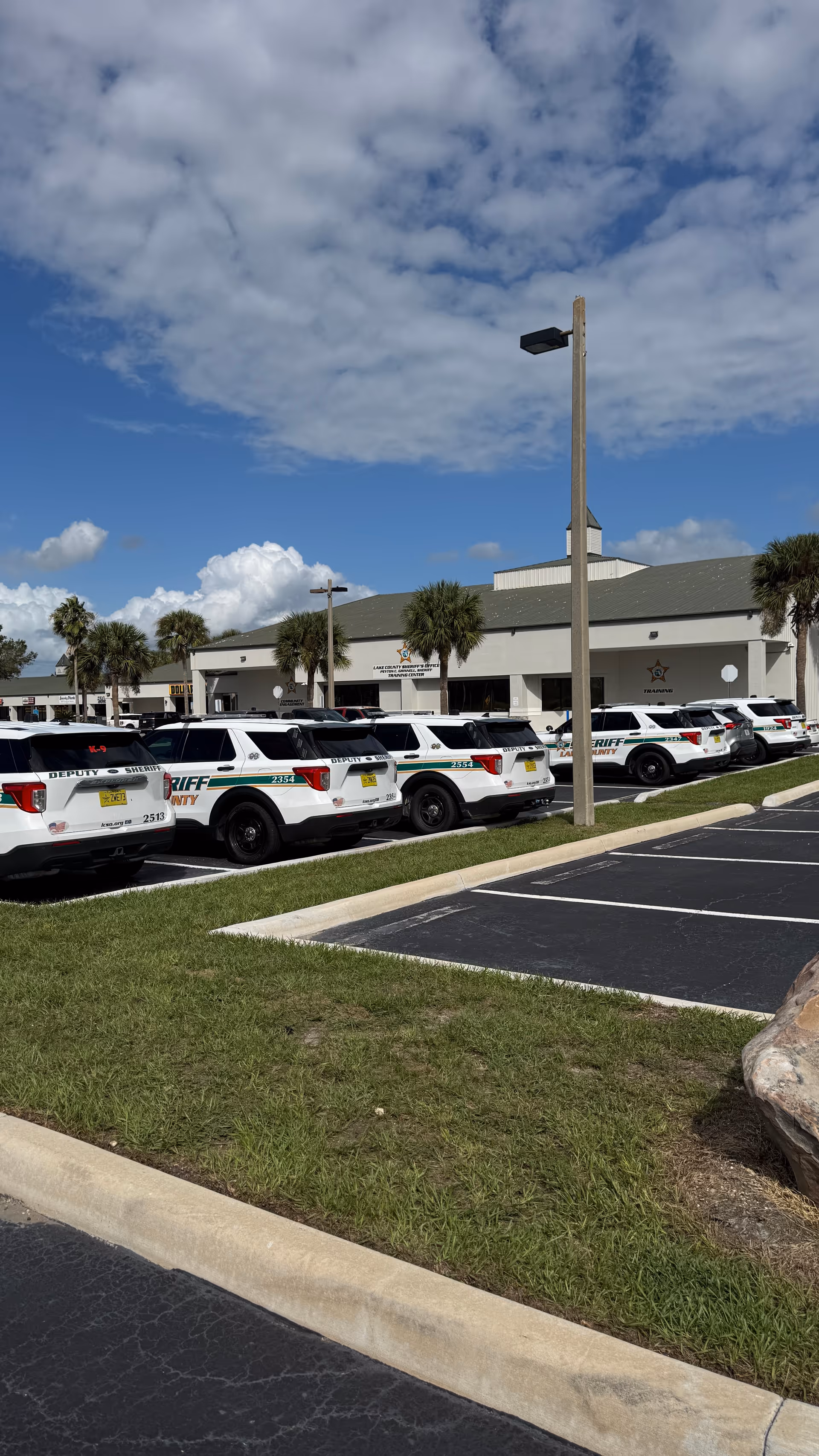 Exterior view of Cornerstone Hospice, Southridge Plaza, with multiple sheriff vehicles in the parking lot.