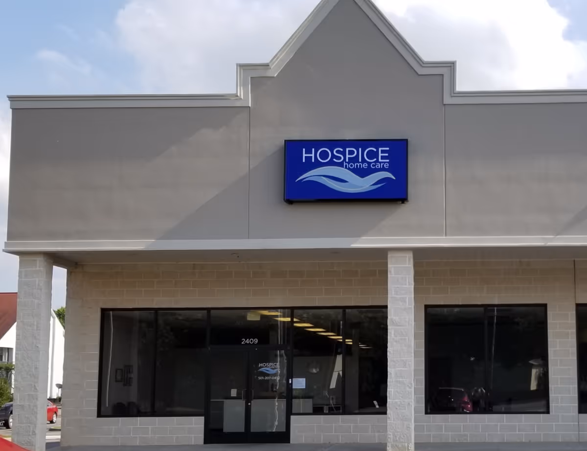 Front of Hospice & Home Care facility with blue sign and glass entry doors.