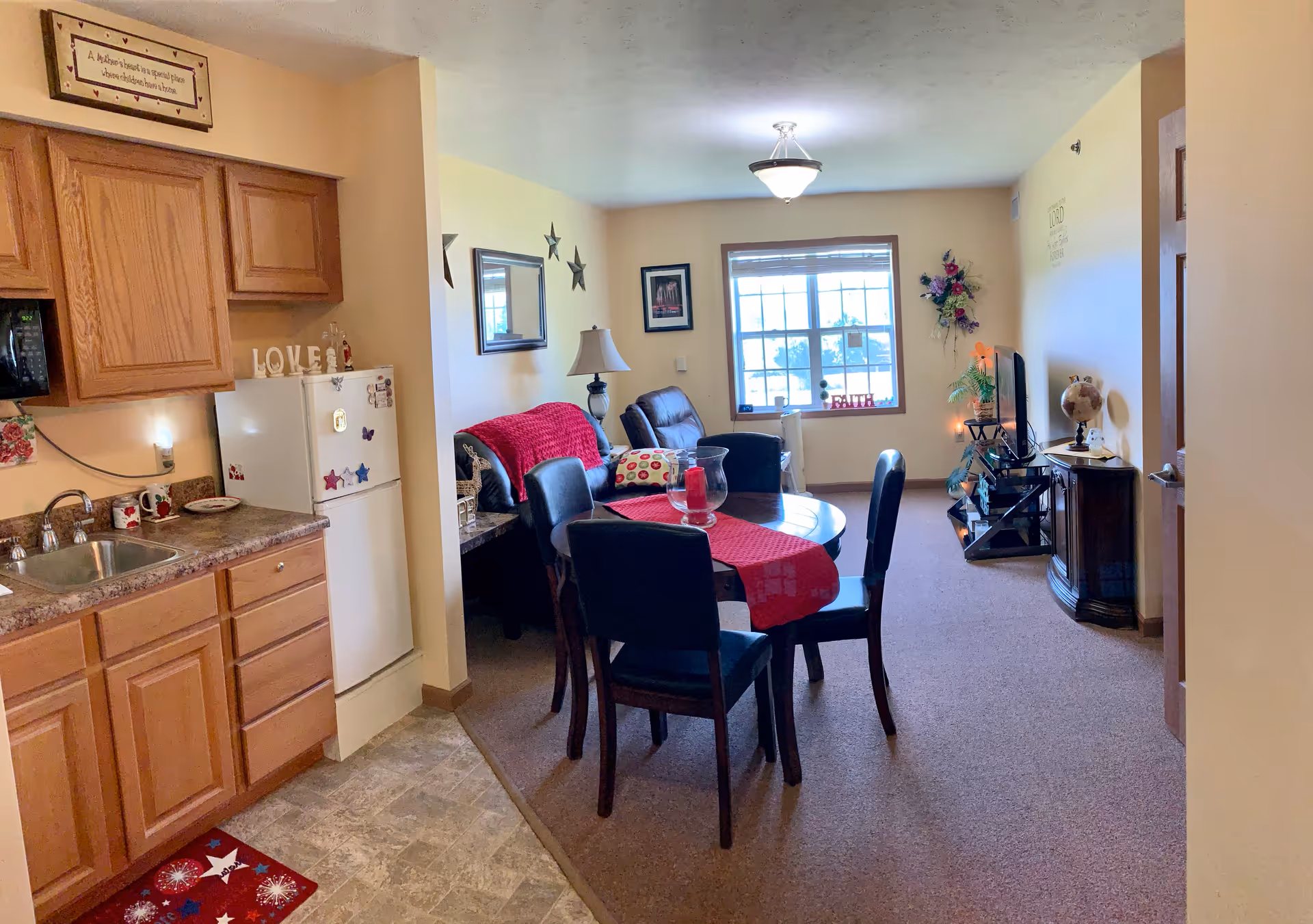 Open-concept living area with kitchen, dining table, and sofas.
