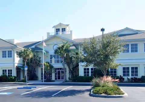 Exterior view of Family Home Health Services facility with palm trees and parking.