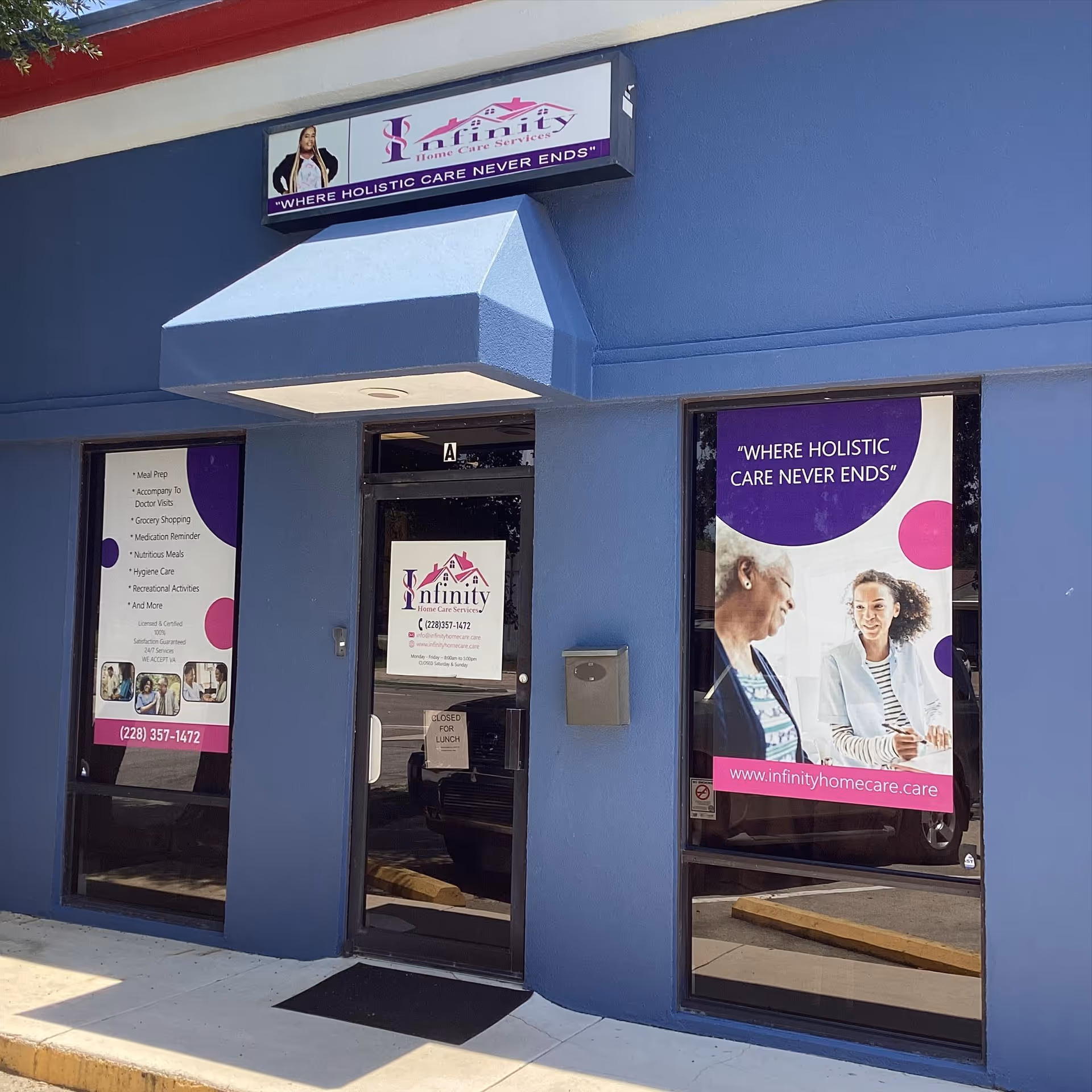 Blue storefront featuring Infinity Home Care Services signage and large window posters.
