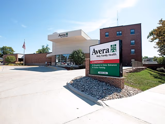 Exterior view of Avera Holy Family Health facility with entrance and prominent sign.