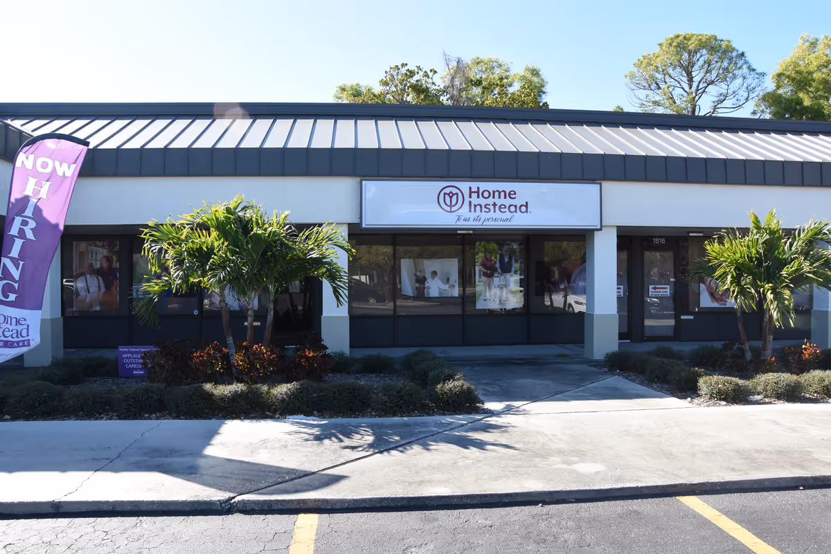 Exterior storefront of Home Instead Bradenton with signage, windows, and palm trees.