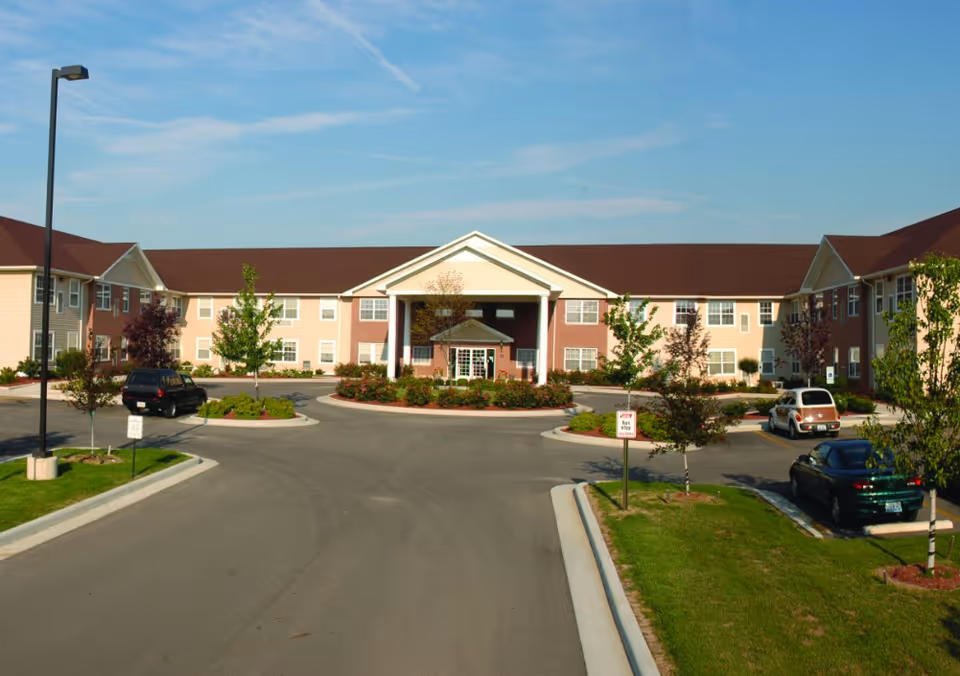 A single-story senior living facility with a central entrance and surrounding parking.