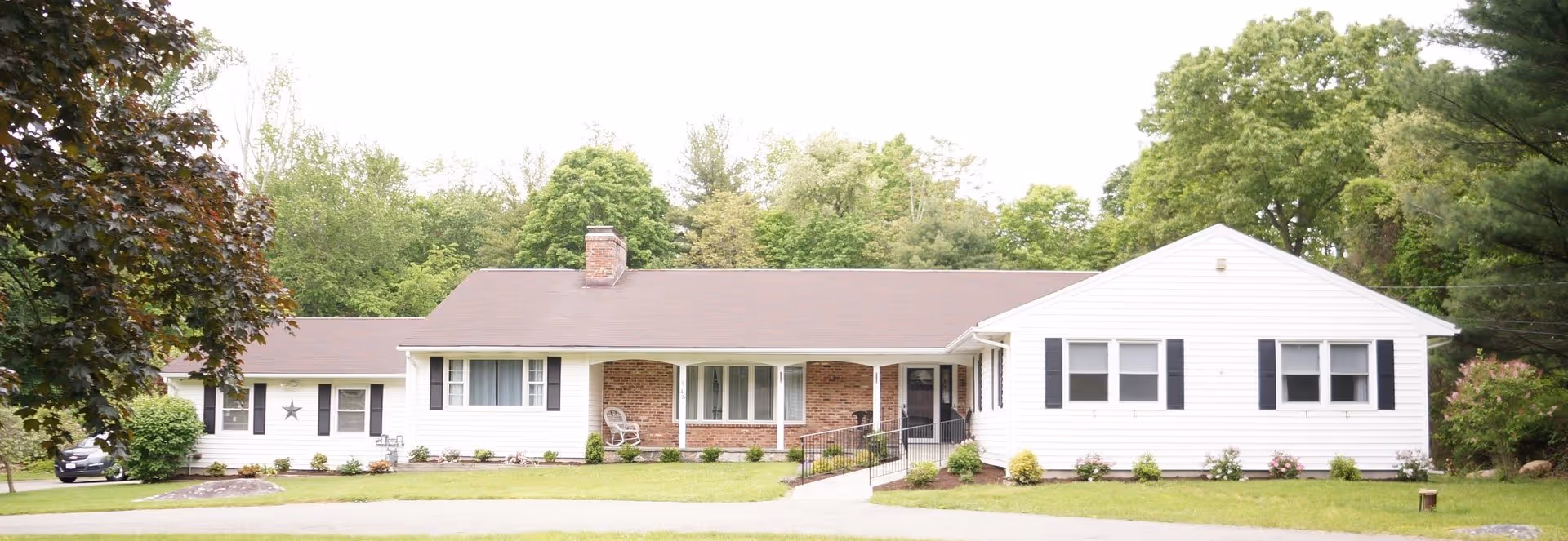 A single-story Sunshine Senior Residence building with manicured lawn and accessible entrance.