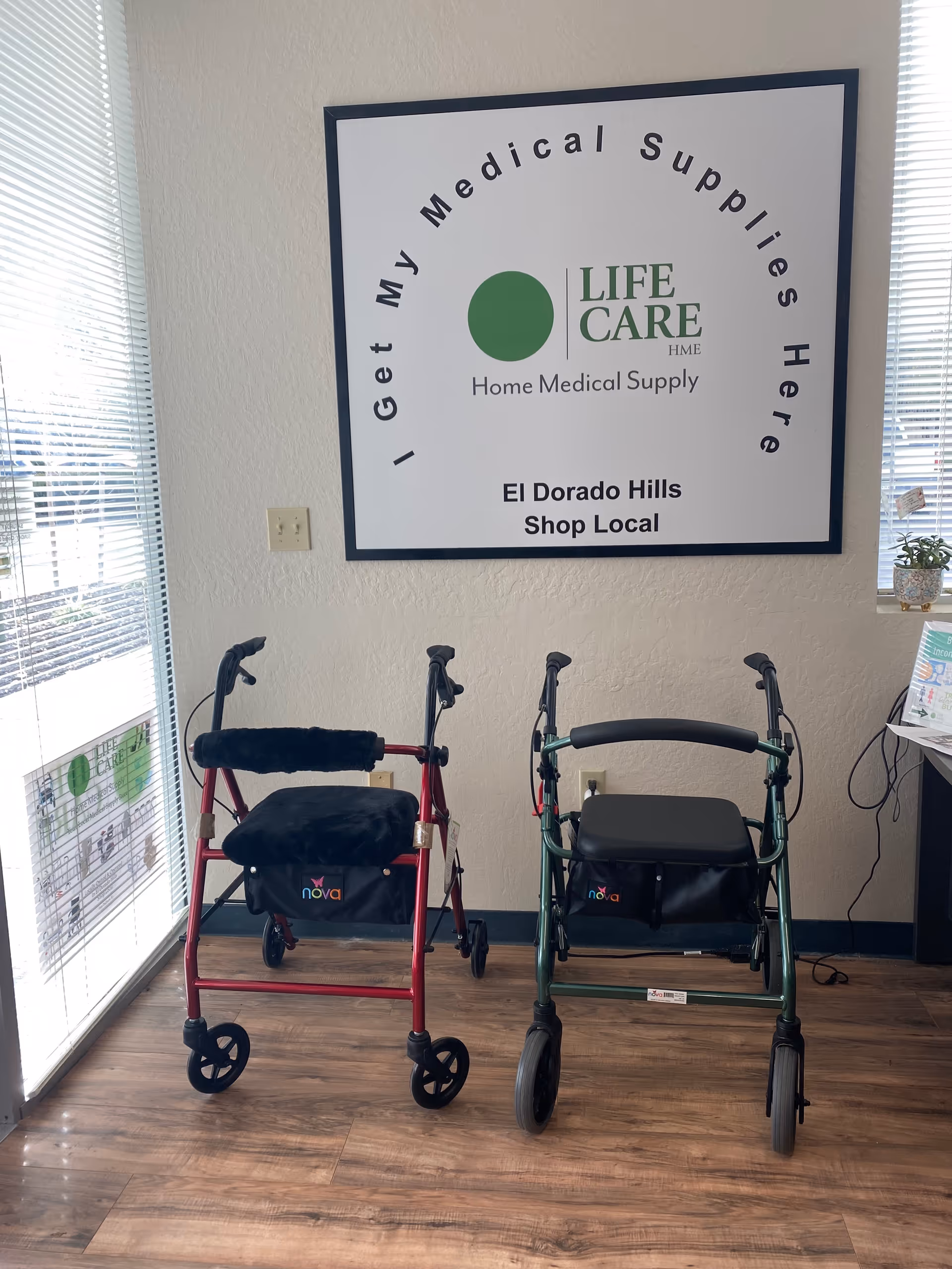 Two wheeled walkers sit in front of a Life Care Medical Supply sign.