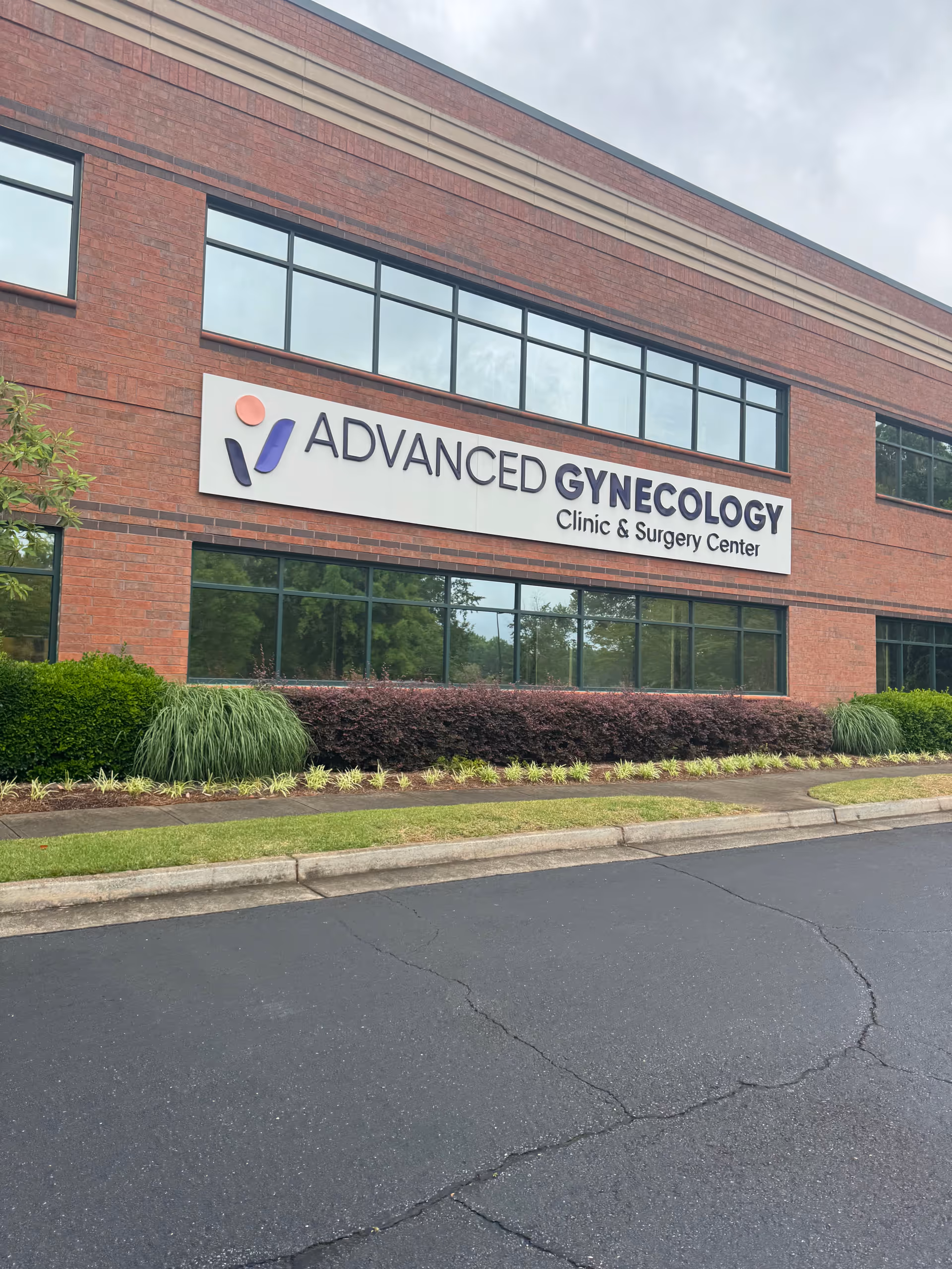 Red brick clinic building with a large Advanced Gynecology sign on the front.