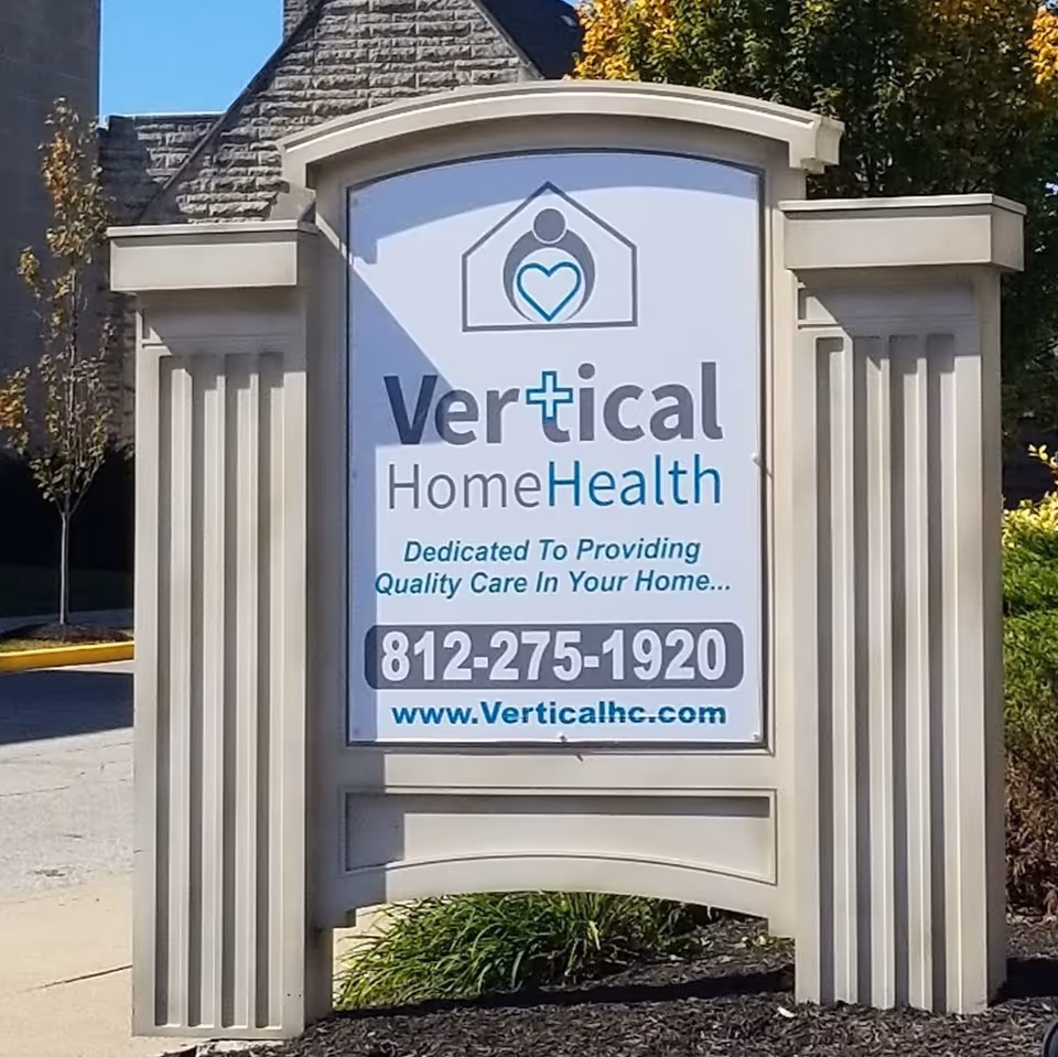 Exterior signboard for Vertical Home Health featuring logo and contact information.