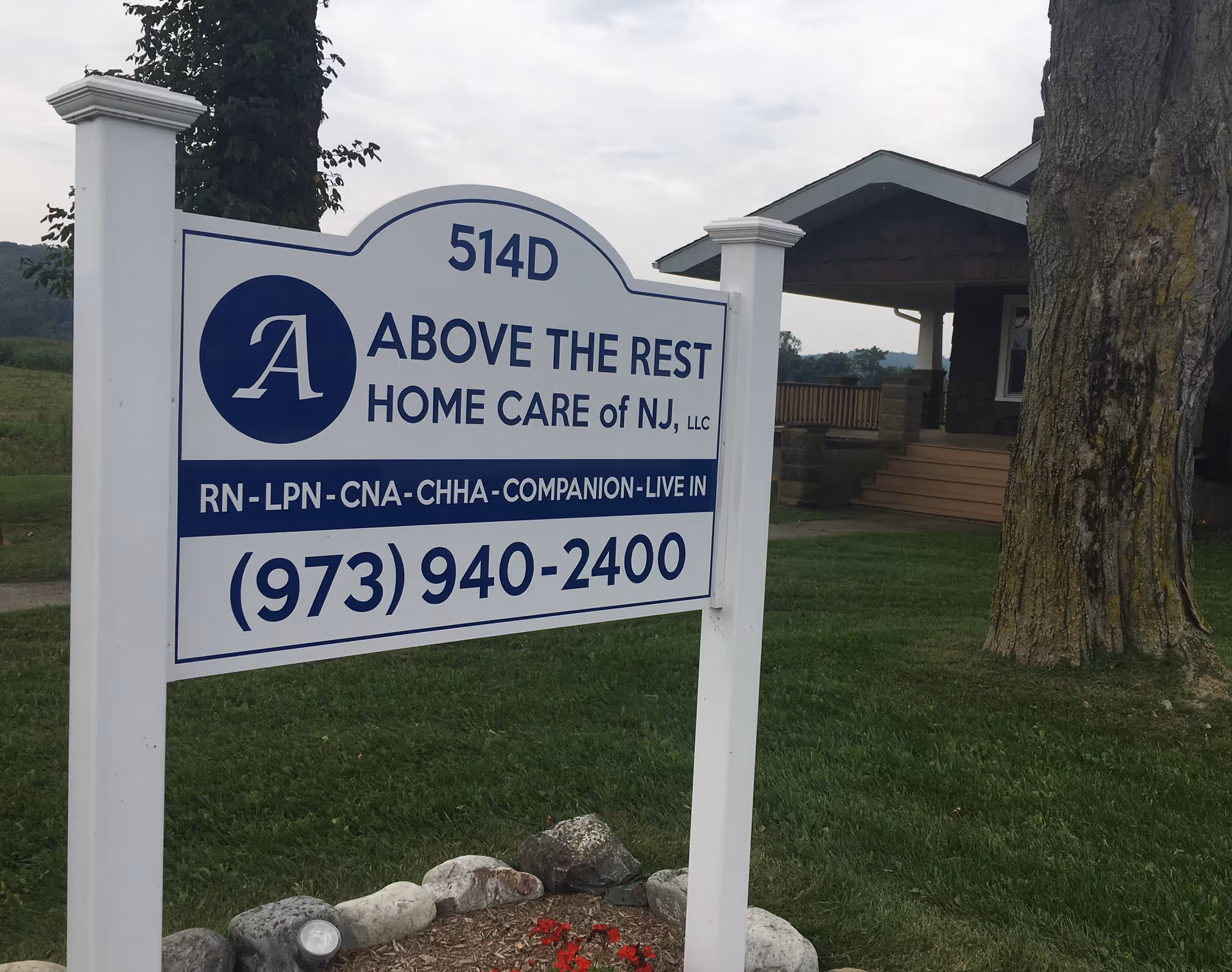 Sign for Above the Rest Home Care of NJ in front of a building.