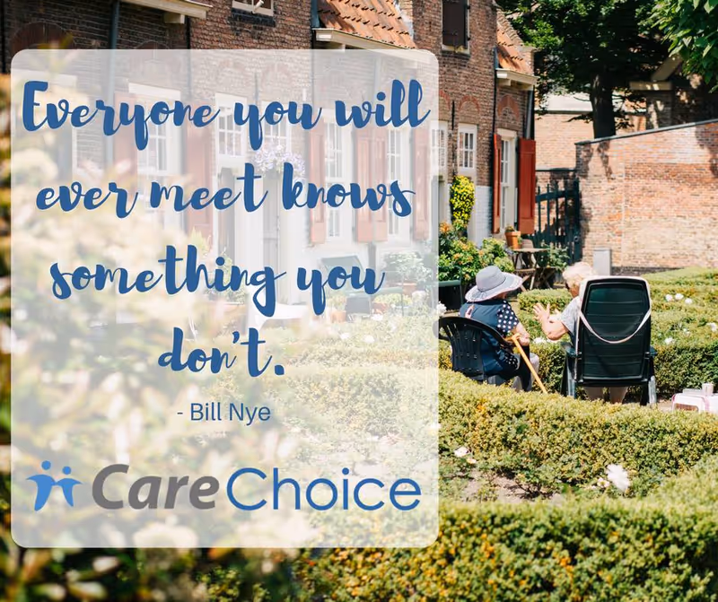 Outdoor CareChoice garden with residents seated in chairs beside wheelchairs.