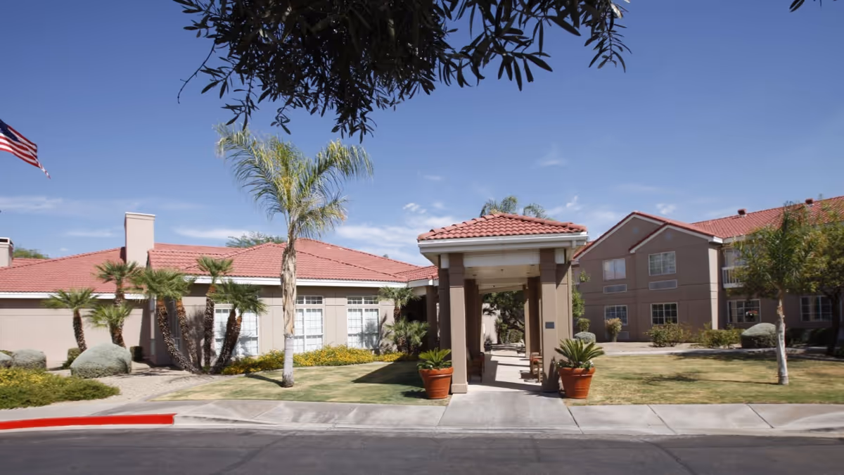 The Gardens of Scottsdale exterior with a covered entrance, palm trees, and landscaping.