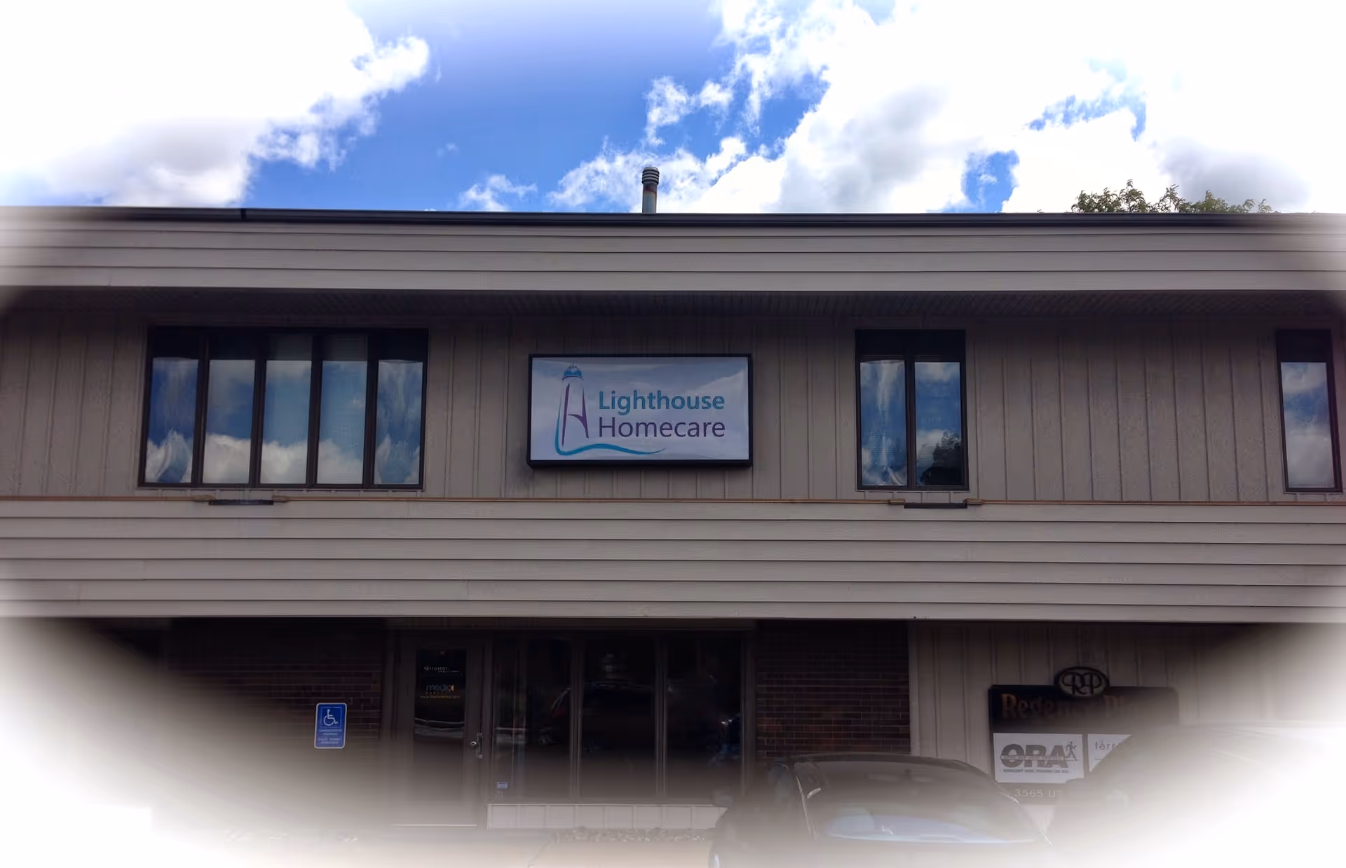 Front exterior of Lighthouse Homecare building with sign and windows.