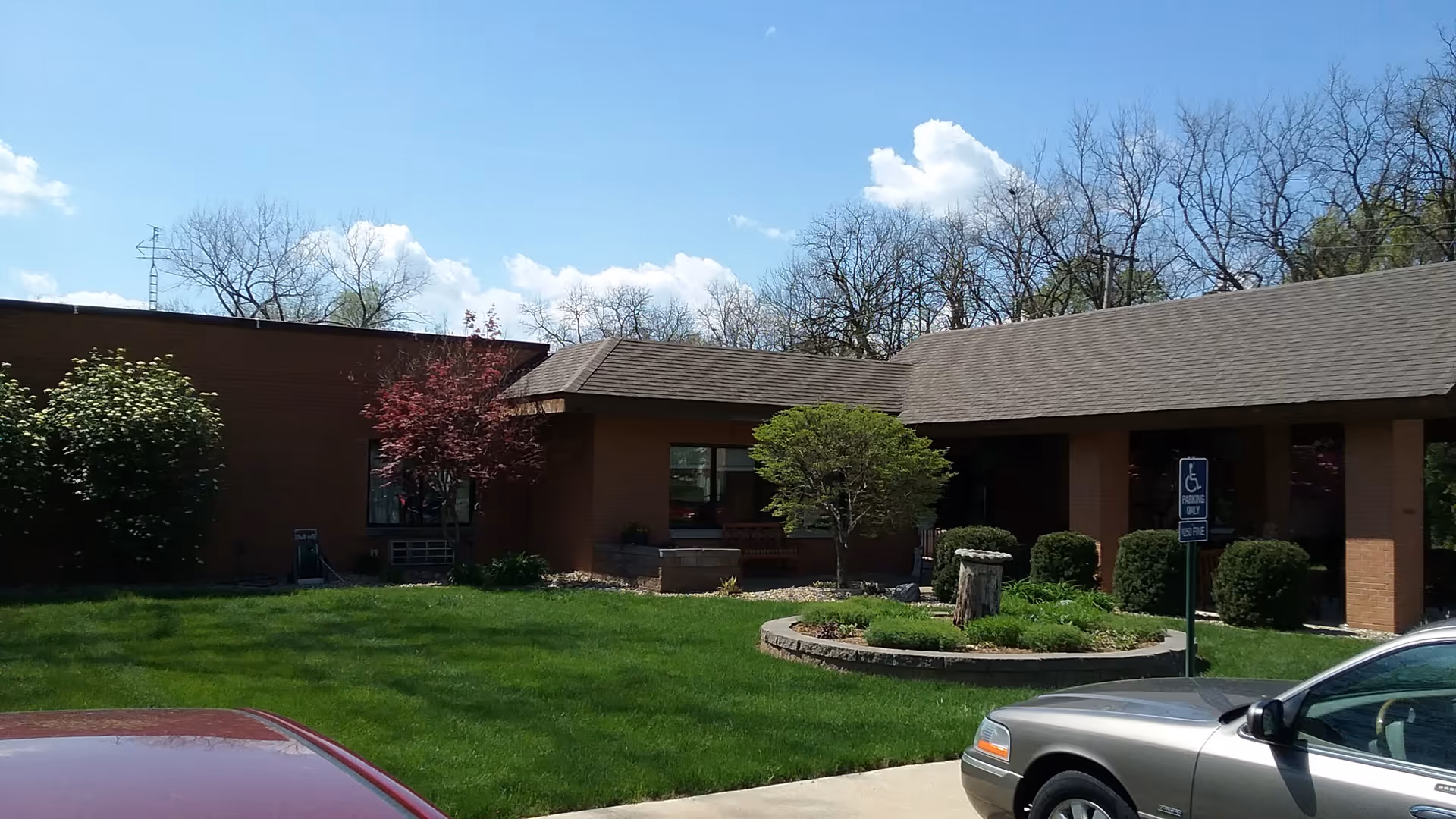 Exterior view of Mount Zion Health and Rehab Center with brick building and landscaped circular island.
