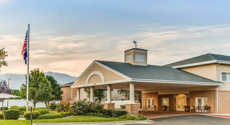 Front exterior of Legacy House of South Jordan with entrance, flagpole, and landscaping.