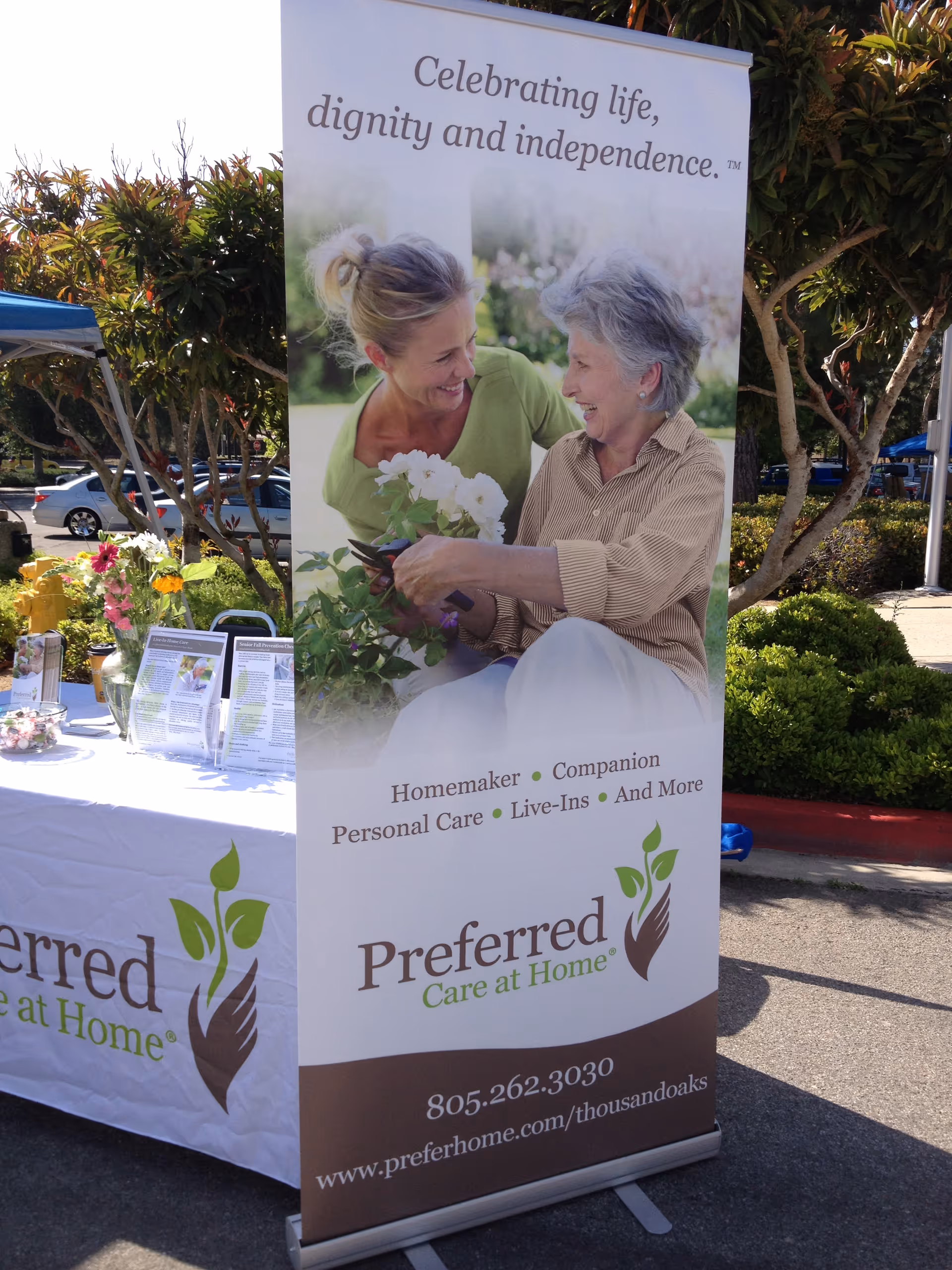Tall outdoor banner for Preferred Care at Home featuring two smiling women.
