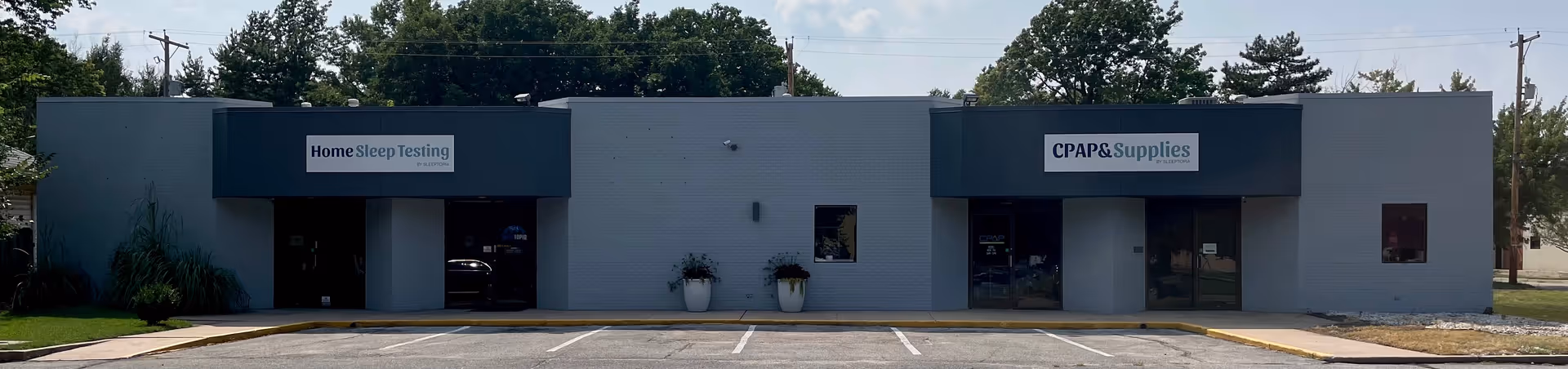 Single-story gray commercial building with two storefronts, signage for Home Sleep Testing and CPAP Supplies.