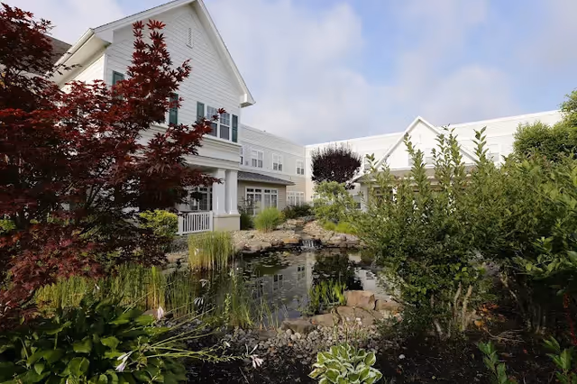 Exterior of Seashore Gardens Living Center with a landscaped pond.