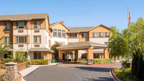 Exterior view of Atria Park of Lafayette with driveway, entrance, and landscaped grounds.