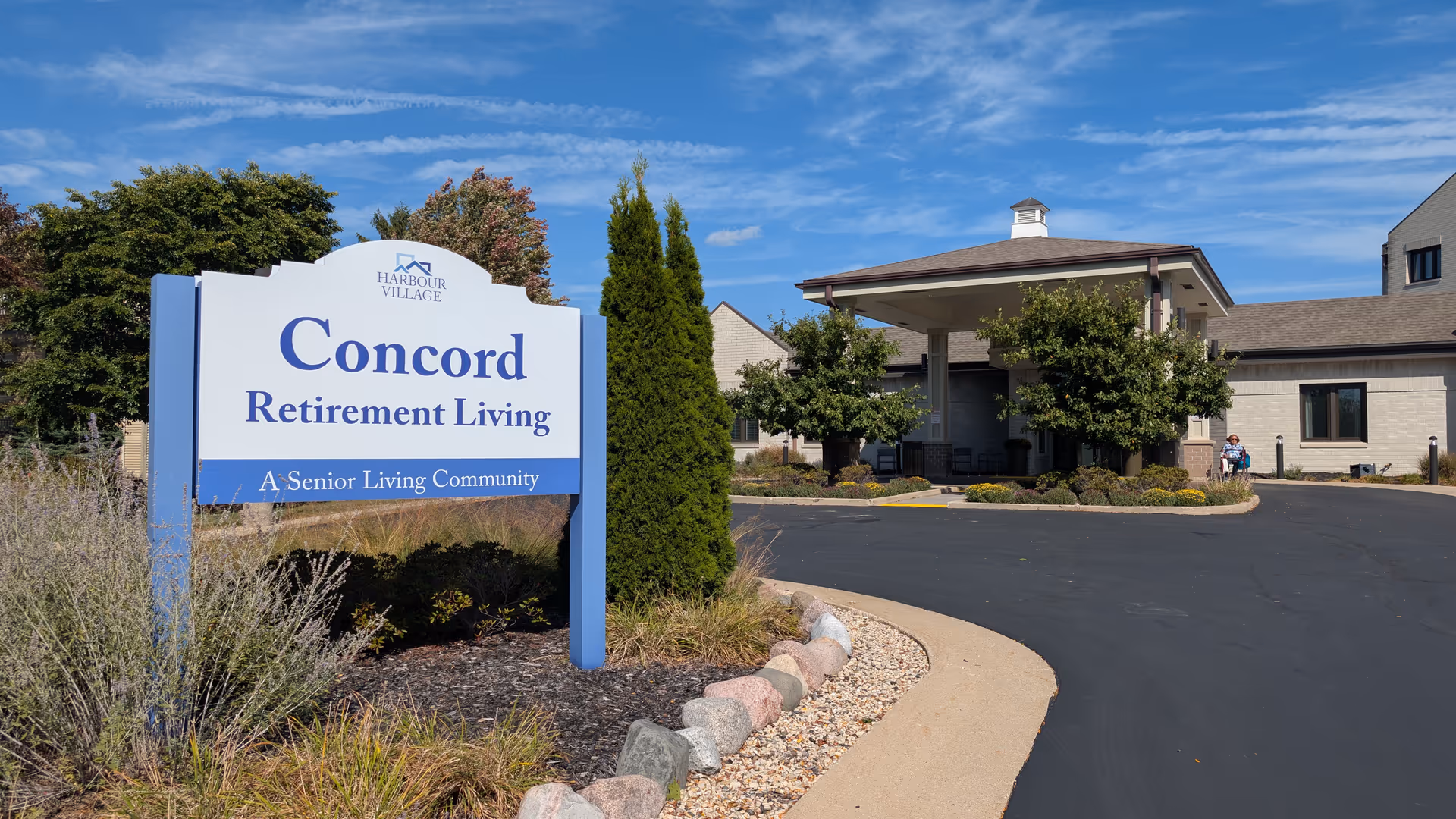 Exterior view of a retirement community with a large Concord Retirement Living sign.