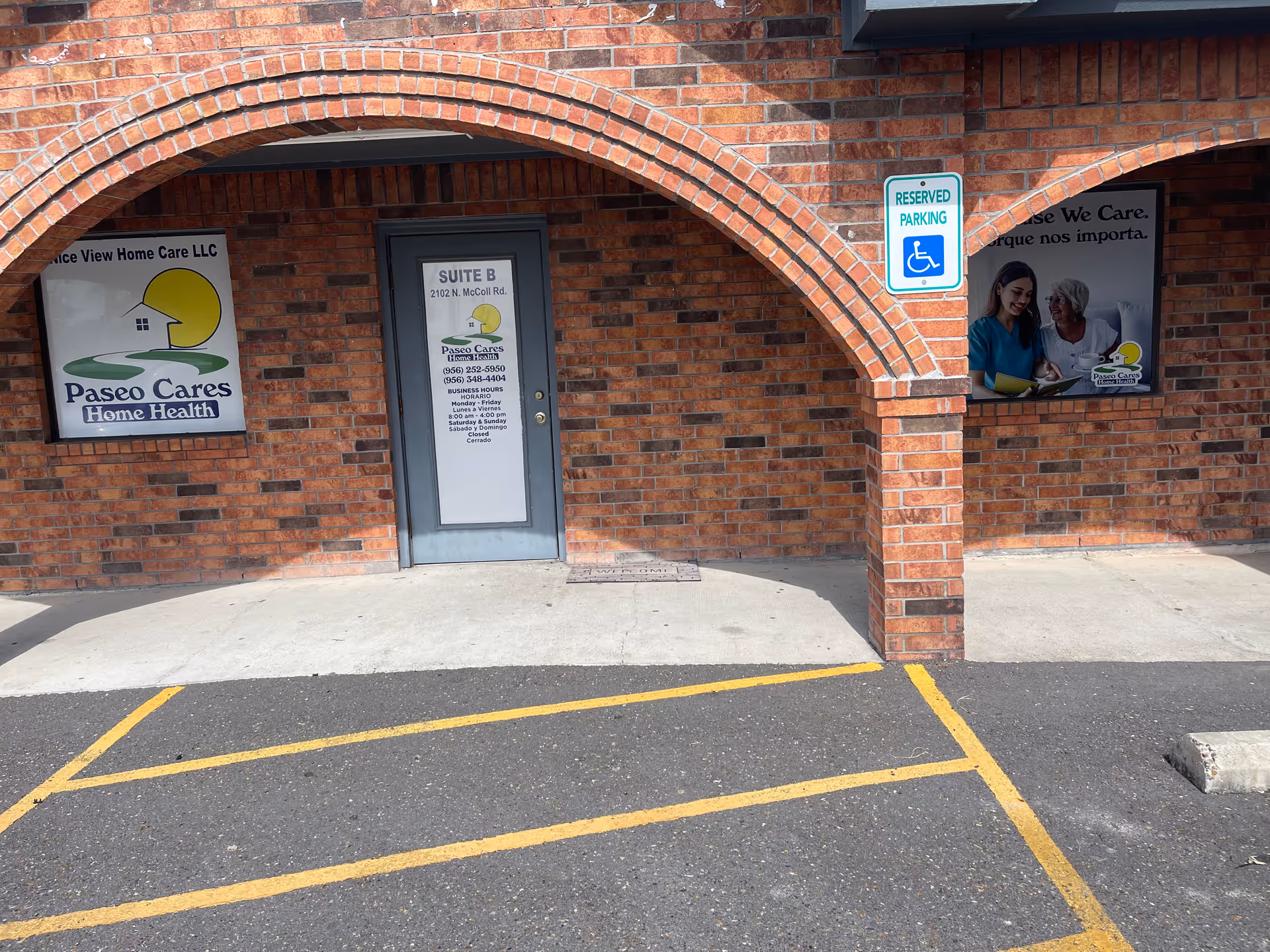 Brick building facade with arched entrance and care facility signage.