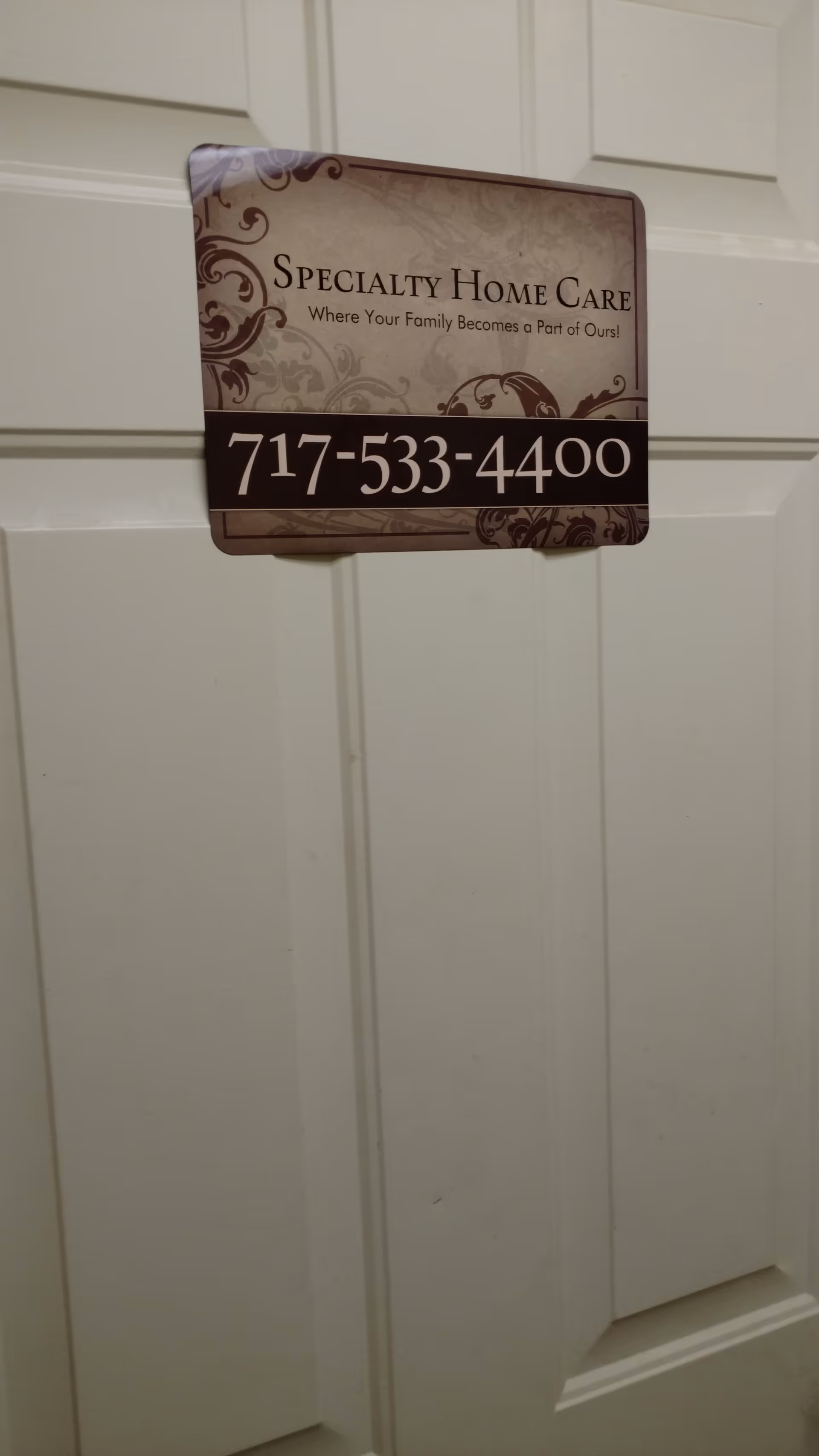 Interior door with Specialty Home Care sign and phone number posted.