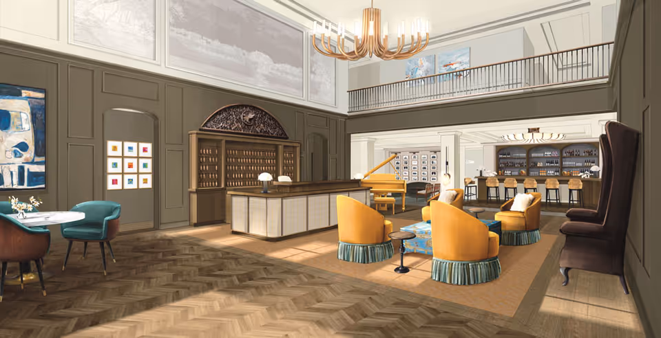 Elegant senior living lobby with seating, a bar, piano, chandelier, and balcony.