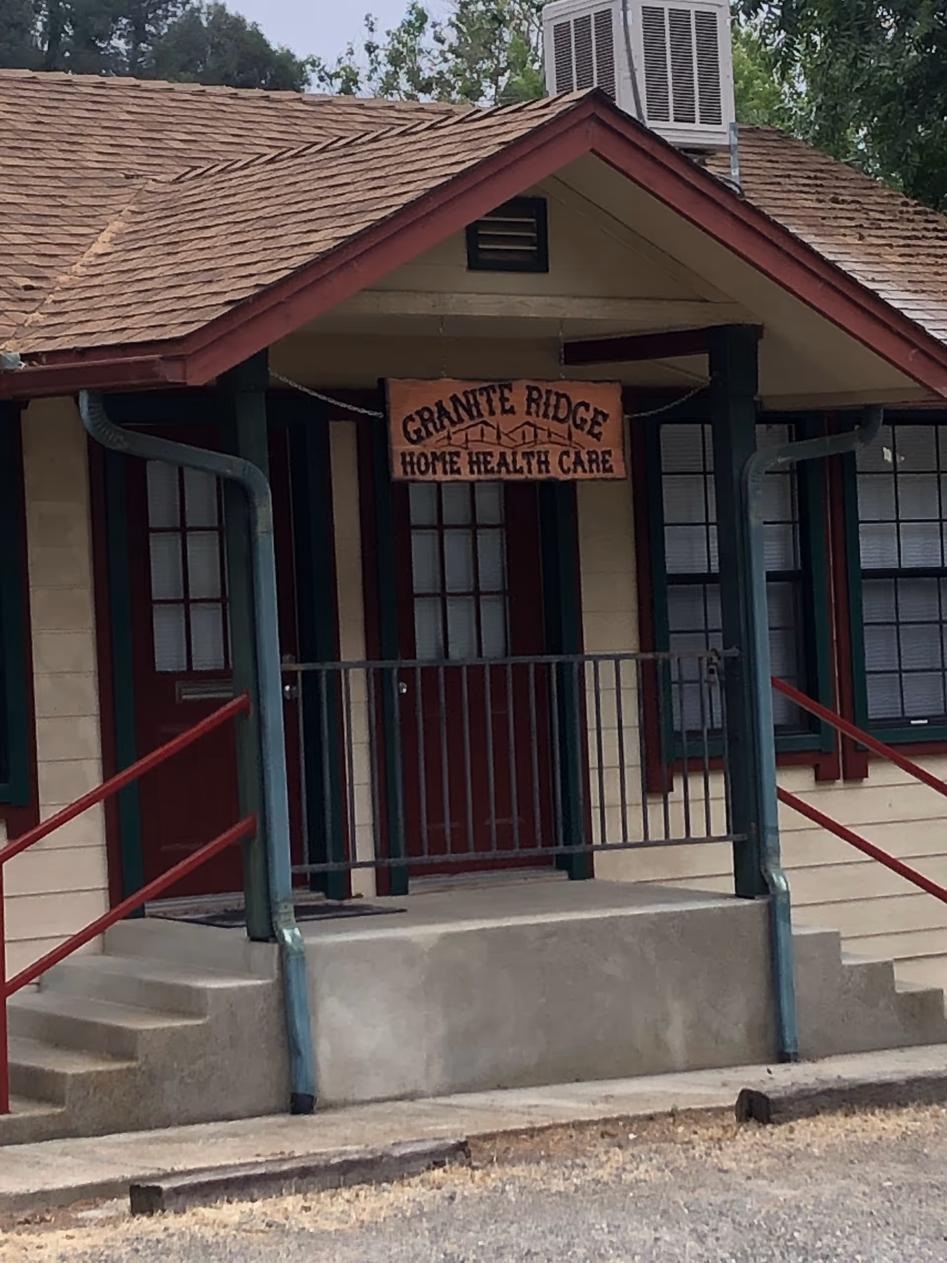 Front entrance of Granite Ridge Home Health Care with sign and railing.