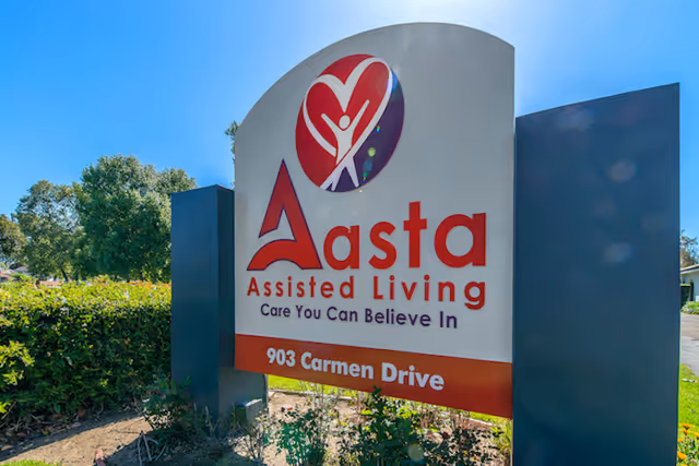 Front outdoor sign for Aasta Assisted Living with logo and slogan.