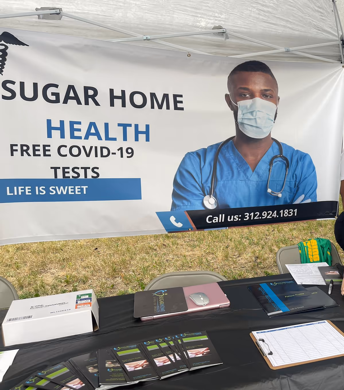 Outdoor health booth banner for Sugar Home Health offering free COVID-19 tests.