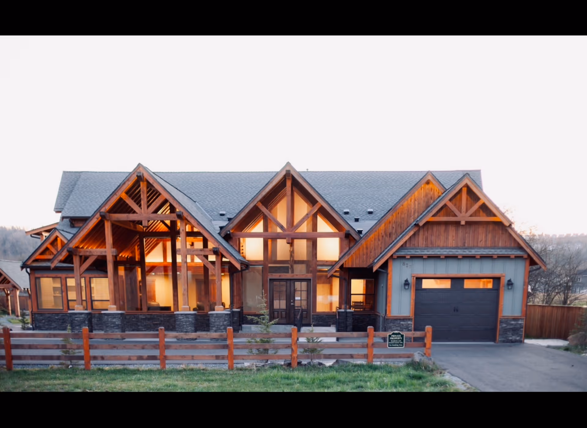 Front view of a rustic lodge-style senior living home with warm lighting
